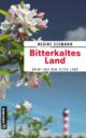 Cover_Bitterkaltes Land_Medium_zeigt Apfelblüte und im Hintergrund einen Leuchtturm